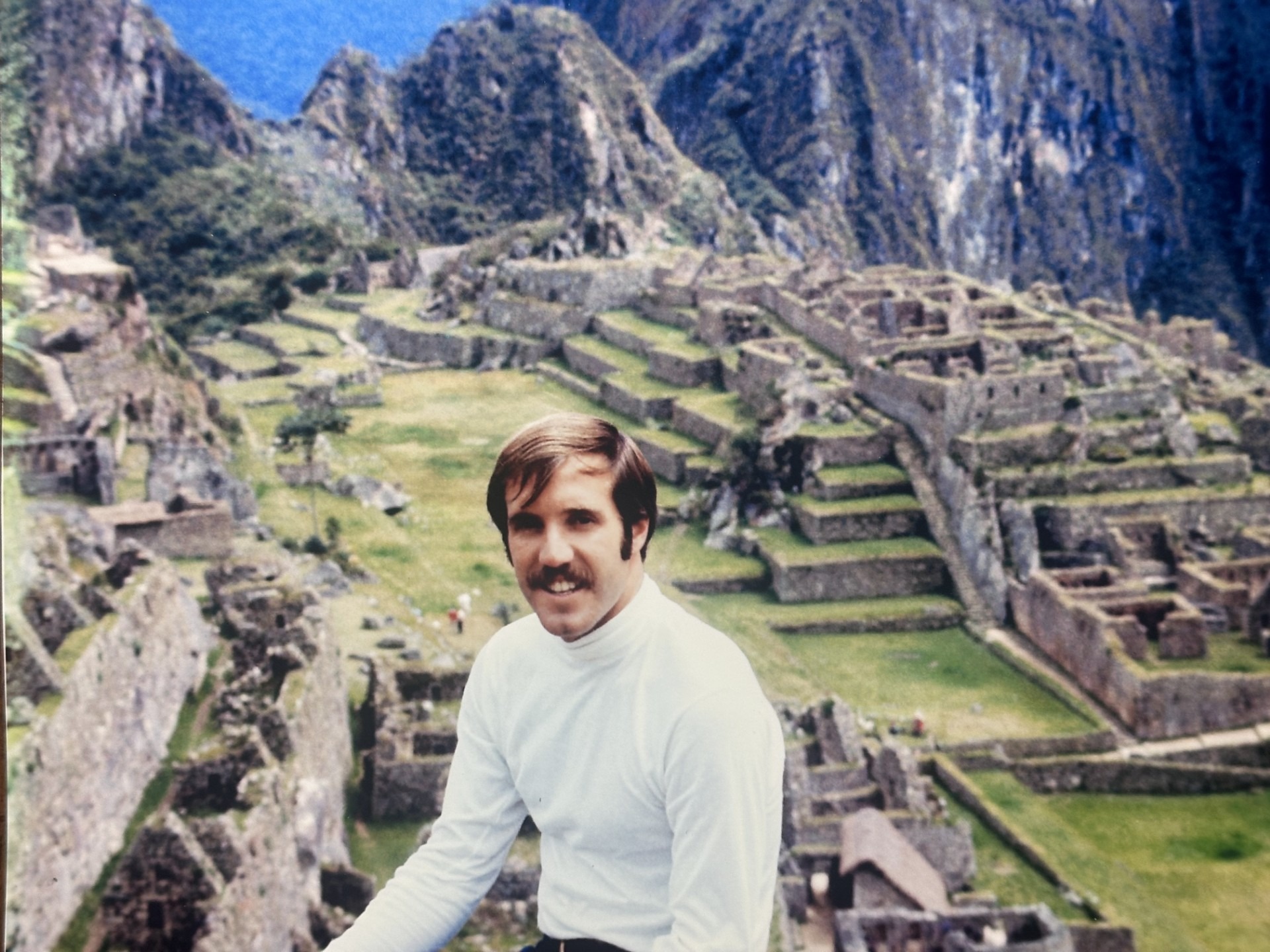 Man posing at Machu Picchu ruins, Peru.